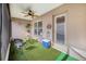 Bright screened porch features artificial turf, ceiling fan, and exterior access at 230 Grouper Ct, Poinciana, FL 34759
