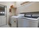 Laundry room with washer, dryer, and ample storage at 3002 Plantation Rd, Winter Haven, FL 33884