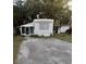 White single-wide mobile home with a screened porch at 3448 Avenue T Nw, Winter Haven, FL 33881