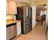 Modern kitchen features a stainless steel refrigerator and granite countertops at 4163 Pirates Lndg, Winter Haven, FL 33884