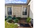 Front entrance with stone detailing and neatly landscaped garden at 4163 Pirates Lndg, Winter Haven, FL 33884