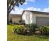 Attractive curb appeal, showcasing a two-car garage and nicely manicured lawn at 4163 Pirates Lndg, Winter Haven, FL 33884