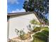 Landscaped exterior showcasing the home's side yard at 4163 Pirates Lndg, Winter Haven, FL 33884