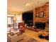 Inviting living room with a brick fireplace, comfortable seating, and large TV at 4163 Pirates Lndg, Winter Haven, FL 33884