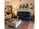 Relaxing living room with leather sofas, a coffee table, and stylish wall art at 4163 Pirates Lndg, Winter Haven, FL 33884