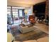 Bright living room showcasing a fireplace, large TV, and access to a sunroom at 4163 Pirates Lndg, Winter Haven, FL 33884