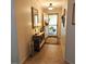 Elegant foyer featuring a console table and mirror reflecting light at 4163 Pirates Lndg, Winter Haven, FL 33884