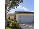 House exterior view, featuring a two-car garage and well-kept landscaping at 4163 Pirates Lndg, Winter Haven, FL 33884