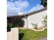 View of home's exterior with landscaping and stone border at 4163 Pirates Lndg, Winter Haven, FL 33884