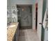 Updated bathroom with granite countertop, walk-in shower, and tiled floor at 4163 Pirates Lndg, Winter Haven, FL 33884