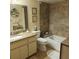 Bathroom with granite countertops, double sinks, and a bathtub at 4163 Pirates Lndg, Winter Haven, FL 33884