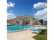Inviting community pool with lounge chairs and a clubhouse at 4163 Pirates Lndg, Winter Haven, FL 33884