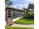 Side view of the home's sunroom and well-maintained lawn at 4163 Pirates Lndg, Winter Haven, FL 33884