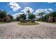 Gated entrance to a luxury community with brick pillars and landscaping at 5051 Tennessee Lake Dr, Auburndale, FL 33823