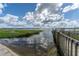 Serene lake view with a wooden dock and lush vegetation at 5051 Tennessee Lake Dr, Auburndale, FL 33823