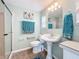 Updated bathroom, featuring a pedestal sink and shower at 6762 Brentwood Ne Dr, Winter Haven, FL 33881