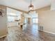 Kitchen features white cabinets, wood-look floors, and a breakfast bar at 6762 Brentwood Ne Dr, Winter Haven, FL 33881