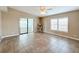 Living room with tile floors, ceiling fan, and access to sunroom at 6762 Brentwood Ne Dr, Winter Haven, FL 33881