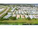 Wide aerial view of a mobile home community near a road and body of water at 6762 Brentwood Ne Dr, Winter Haven, FL 33881