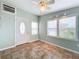 Bright and airy living room with tile floor, updated door, and window blinds at 6762 Brentwood Ne Dr, Winter Haven, FL 33881