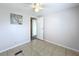 Simple bedroom with tile floors and ceiling fan at 6762 Brentwood Ne Dr, Winter Haven, FL 33881