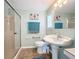 Clean bathroom with pedestal sink and shower at 6762 Brentwood Ne Dr, Winter Haven, FL 33881