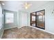 Bright sunroom features tile flooring, a ceiling fan, and sliding glass doors at 6762 Brentwood Ne Dr, Winter Haven, FL 33881
