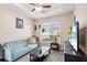 Cozy living room featuring a comfy sofa and large window at 1013 Robin Ln, Winter Haven, FL 33884