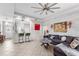 Bright living room features a sectional sofa and a view into the kitchen at 1013 Robin Ln, Winter Haven, FL 33884