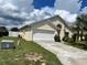 House exterior with a driveway and landscaping at 123 Osprey Heights Dr, Winter Haven, FL 33880