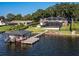 Luxury waterfront home with private dock, boat lift, and screened pool; expansive backyard at 1324 Mirror Nw Ter, Winter Haven, FL 33881