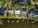 Bird's eye view of lakefront homes with lush green lawns at 1324 Mirror Nw Ter, Winter Haven, FL 33881