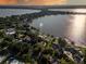 Stunning sunset aerial view of lakefront home and neighborhood at 1324 Mirror Nw Ter, Winter Haven, FL 33881