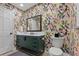 Stylish bathroom with a modern vanity, patterned wallpaper, and a toilet at 1324 Mirror Nw Ter, Winter Haven, FL 33881