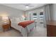 Bright bedroom with lake view, king bed, and modern dresser at 1324 Mirror Nw Ter, Winter Haven, FL 33881