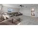 Bonus room with sectional sofa and access to laundry at 1324 Mirror Nw Ter, Winter Haven, FL 33881