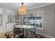 Dining area with a marble table and stunning lake view at 1324 Mirror Nw Ter, Winter Haven, FL 33881