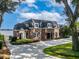Brick home with circular driveway and lake view at 1324 Mirror Nw Ter, Winter Haven, FL 33881