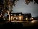 Night view of a brick home with landscape lighting at 1324 Mirror Nw Ter, Winter Haven, FL 33881