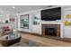Brick fireplace with built-in shelving and large TV at 1324 Mirror Nw Ter, Winter Haven, FL 33881
