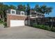 Brick house with attached white garage door and landscaped area at 1324 Mirror Nw Ter, Winter Haven, FL 33881