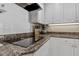 Modern kitchen featuring granite countertops and a sleek cooktop at 1324 Mirror Nw Ter, Winter Haven, FL 33881