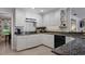 White kitchen with granite counters and stainless steel appliances at 1324 Mirror Nw Ter, Winter Haven, FL 33881