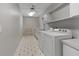 Laundry room with washer, dryer, cabinets, and tile flooring at 1324 Mirror Nw Ter, Winter Haven, FL 33881