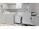 Laundry room with built-in desk, washer, dryer, and cabinets at 1324 Mirror Nw Ter, Winter Haven, FL 33881