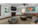 Spacious living room featuring a cozy sectional sofa and a large TV at 1324 Mirror Nw Ter, Winter Haven, FL 33881