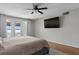 Main bedroom with lake view, king bed, and hardwood floors at 1324 Mirror Nw Ter, Winter Haven, FL 33881