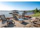 Relaxing patio area with lake view and fire pit at 1324 Mirror Nw Ter, Winter Haven, FL 33881