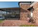 Brick patio with access to covered patio and pool at 1324 Mirror Nw Ter, Winter Haven, FL 33881