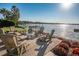 Lakefront patio with fire pit and seating area at 1324 Mirror Nw Ter, Winter Haven, FL 33881